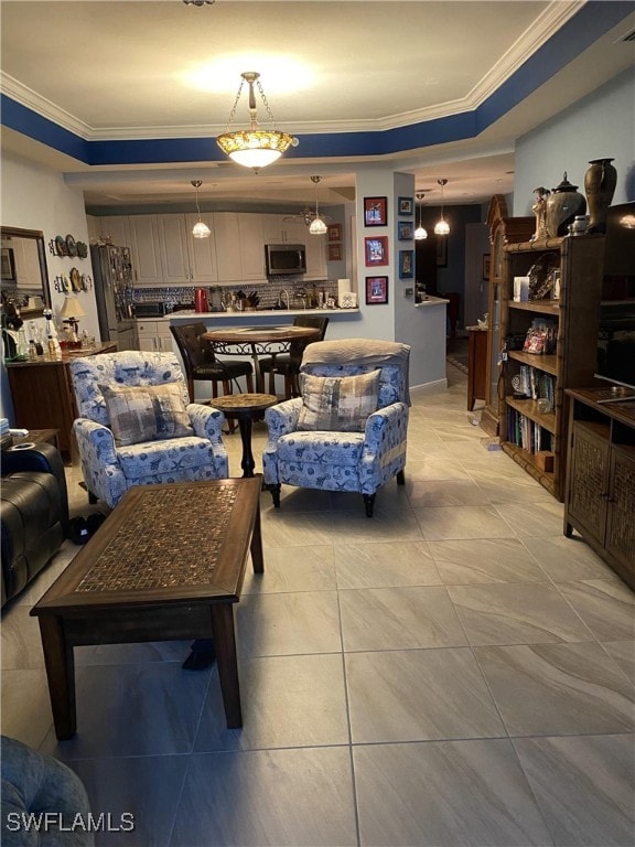 tiled living room with ornamental molding and a tray ceiling