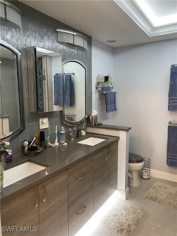 bathroom with tiled shower, toilet, tile patterned flooring, vanity, and crown molding