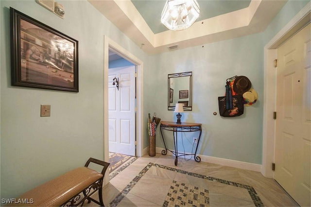 foyer featuring a tray ceiling