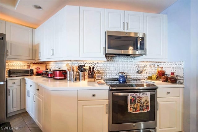 kitchen featuring white cabinetry, backsplash, and appliances with stainless steel finishes