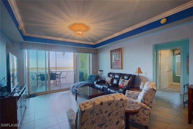 tiled living room with ornamental molding and a tray ceiling