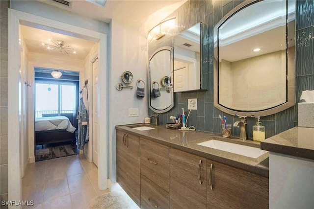 bathroom featuring vanity, tile patterned floors, and backsplash