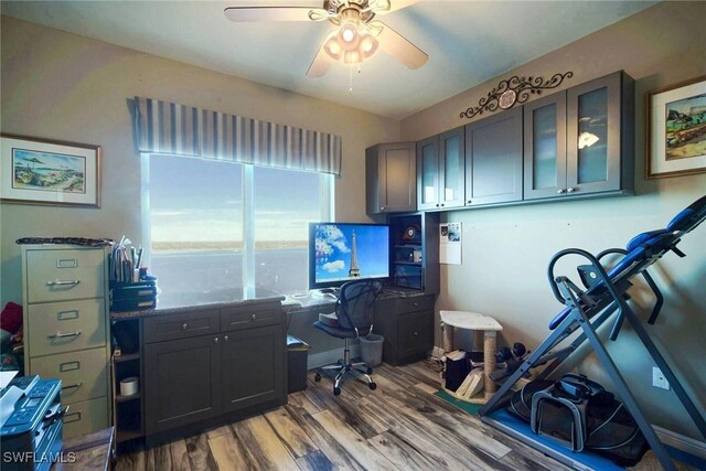 home office featuring hardwood / wood-style flooring and ceiling fan