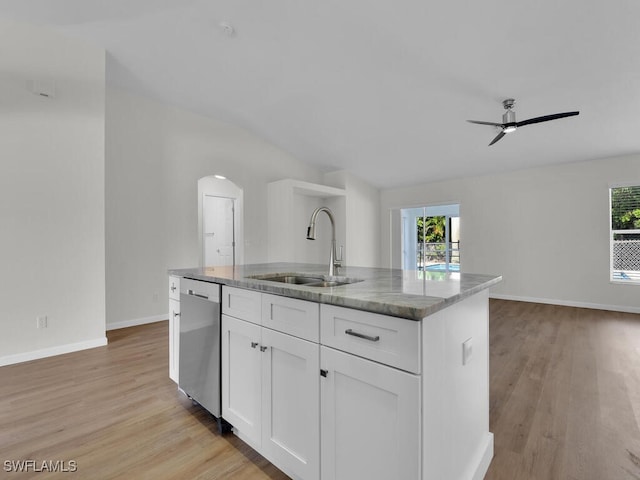 kitchen with sink, an island with sink, white cabinetry, stainless steel dishwasher, and light hardwood / wood-style flooring