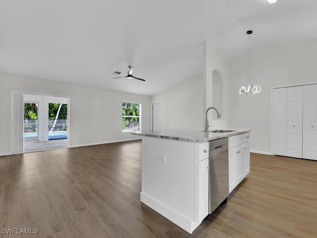 kitchen with white cabinetry, light hardwood / wood-style floors, decorative light fixtures, stainless steel dishwasher, and a kitchen island with sink