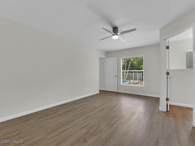 spare room with hardwood / wood-style flooring and ceiling fan