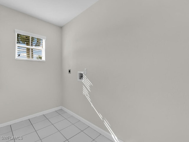 laundry area with hookup for an electric dryer, hookup for a washing machine, and light tile patterned floors