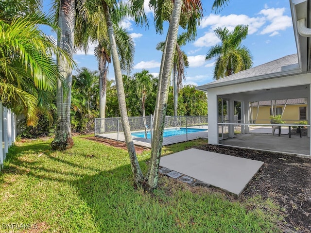 view of yard featuring a patio area and a fenced in pool