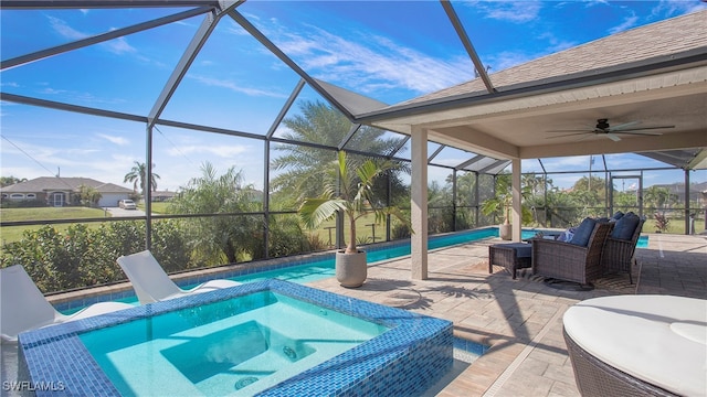 view of pool featuring a patio area, an in ground hot tub, ceiling fan, and glass enclosure