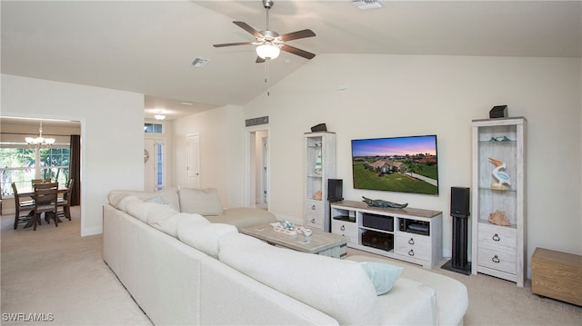 living room featuring ceiling fan with notable chandelier, light colored carpet, and lofted ceiling