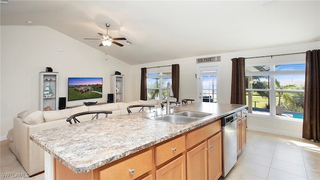 kitchen with sink, stainless steel dishwasher, an island with sink, vaulted ceiling, and light tile patterned floors