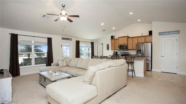 carpeted living room with vaulted ceiling and ceiling fan