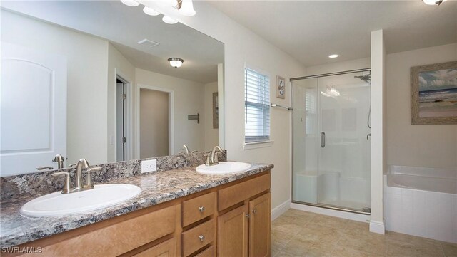 bathroom with plus walk in shower, vanity, and tile patterned flooring