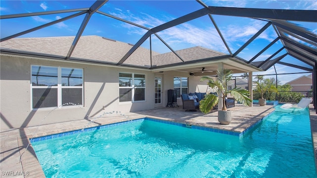 view of pool featuring a lanai, ceiling fan, and a patio area