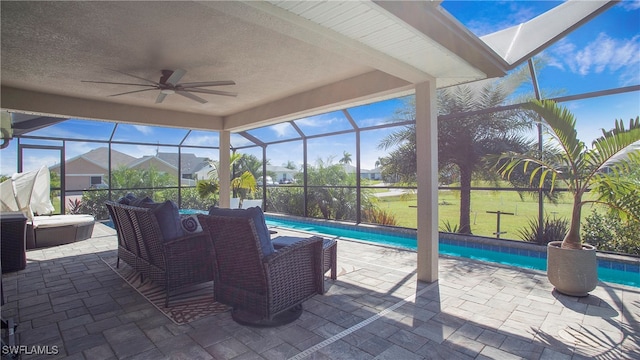 exterior space featuring ceiling fan and glass enclosure