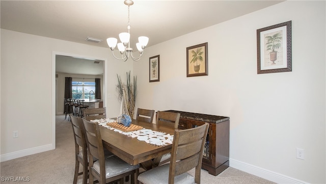 carpeted dining area with a notable chandelier