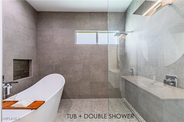 bathroom with tile patterned flooring, sink, and plus walk in shower