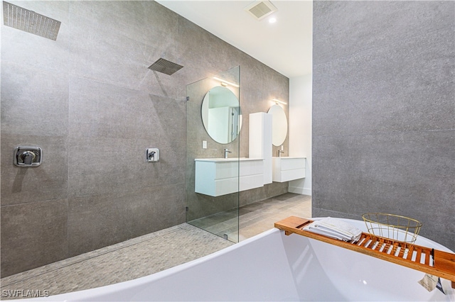 bathroom featuring vanity and separate shower and tub