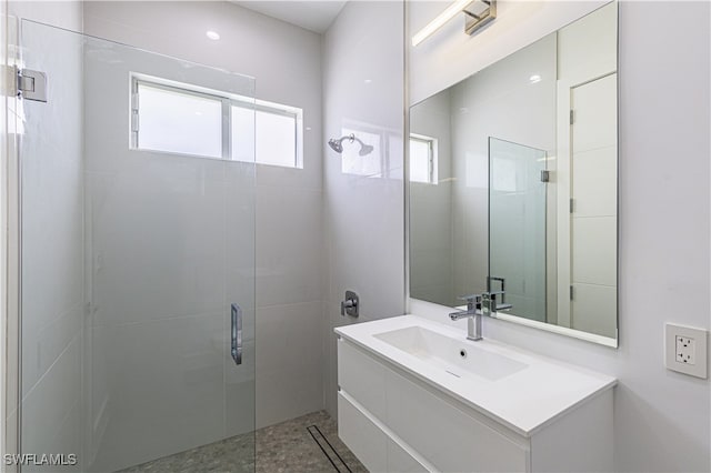 bathroom featuring vanity and a shower with shower door