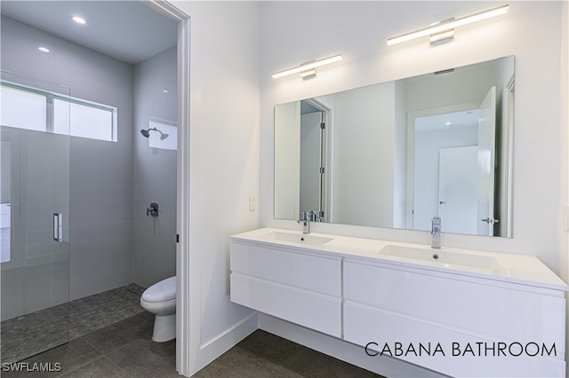 bathroom with walk in shower, tile patterned floors, vanity, and toilet