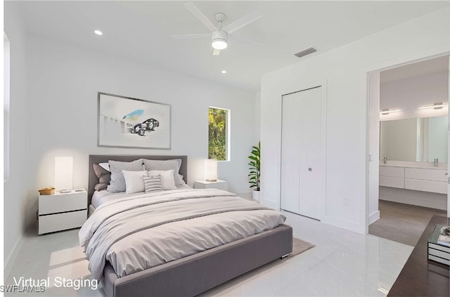 bedroom featuring ensuite bathroom, ceiling fan, and a closet