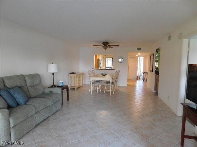 living room featuring light tile patterned floors and ceiling fan