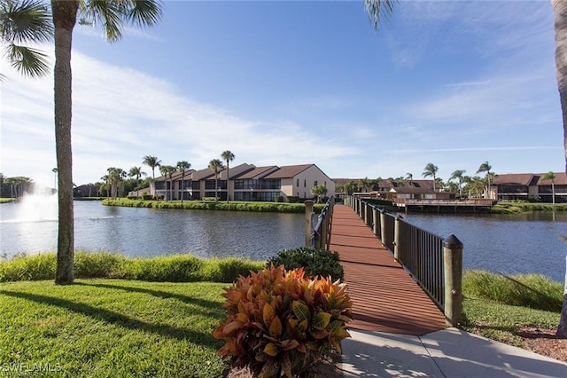 view of dock featuring a water view and a lawn