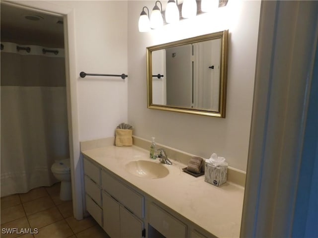 bathroom featuring a shower with shower curtain, vanity, toilet, and tile patterned flooring