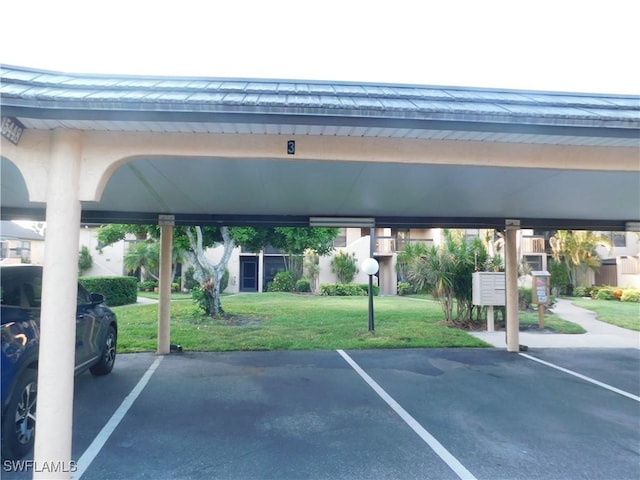 view of vehicle parking with a carport and a yard