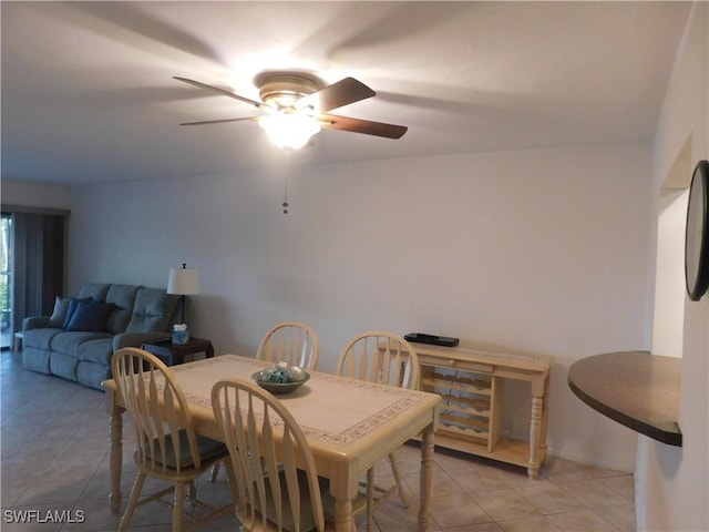 tiled dining area featuring ceiling fan