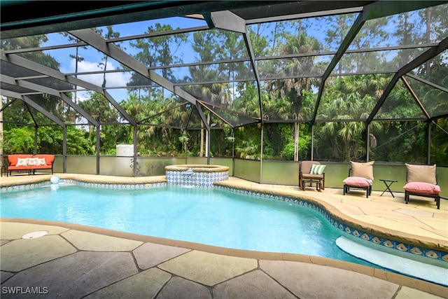 view of pool featuring a patio, glass enclosure, and an in ground hot tub