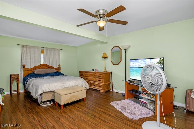 bedroom featuring ceiling fan, beamed ceiling, and dark hardwood / wood-style flooring