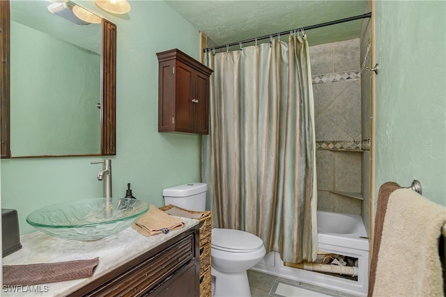 full bathroom featuring tile patterned flooring, shower / bath combo, vanity, and toilet