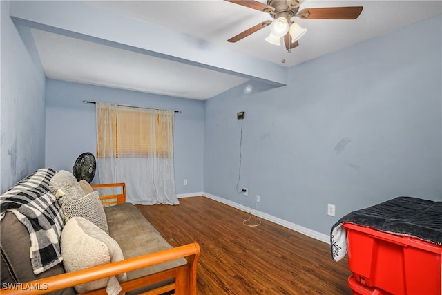 living area featuring dark hardwood / wood-style floors and ceiling fan