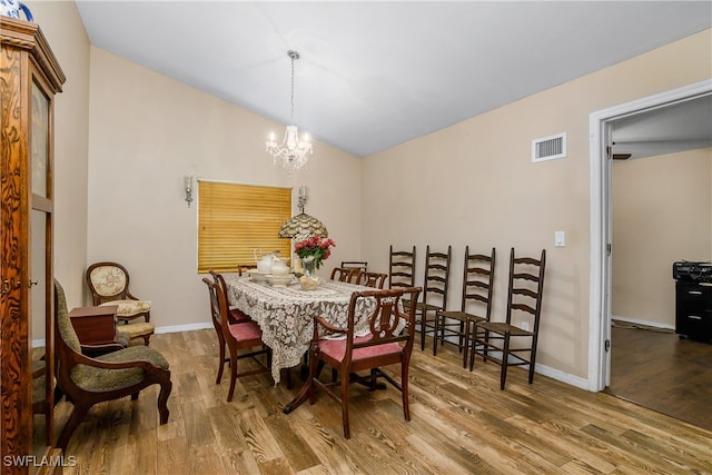 dining room featuring a notable chandelier and wood-type flooring