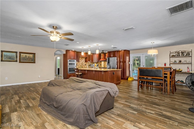 living room with french doors, ceiling fan, hardwood / wood-style floors, and sink