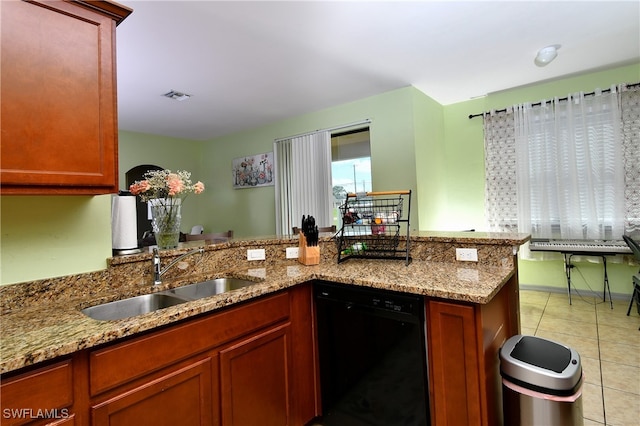 kitchen with light tile patterned flooring, sink, kitchen peninsula, black dishwasher, and light stone countertops