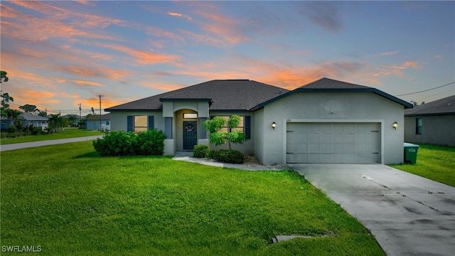 view of front of house with a lawn and a garage