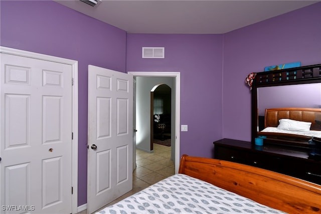 bedroom with a closet and light tile patterned floors