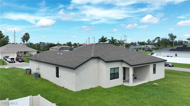 view of home's exterior featuring a yard and central AC unit