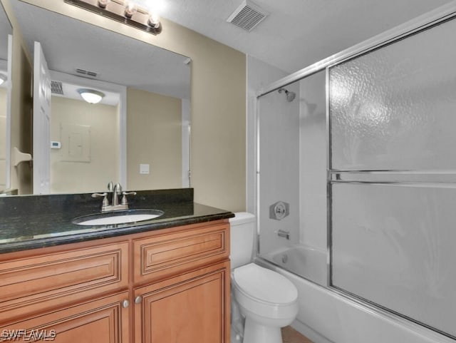 full bathroom featuring vanity, toilet, and shower / bath combination with glass door