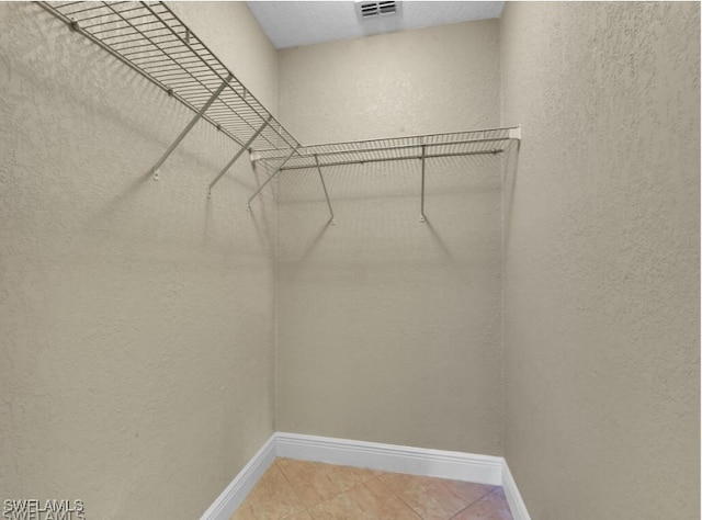 spacious closet featuring tile patterned floors