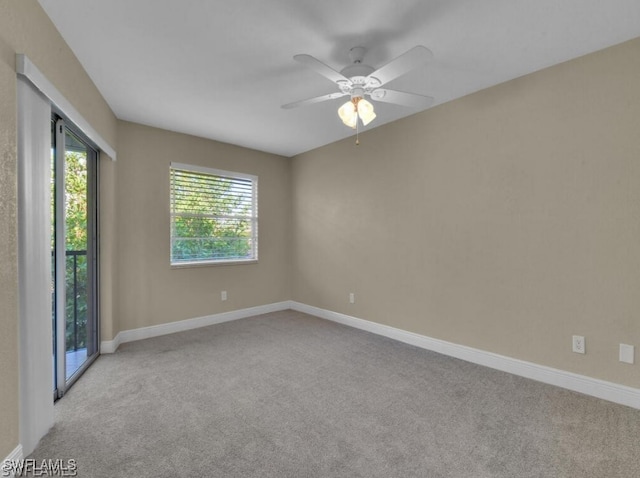 carpeted empty room featuring ceiling fan