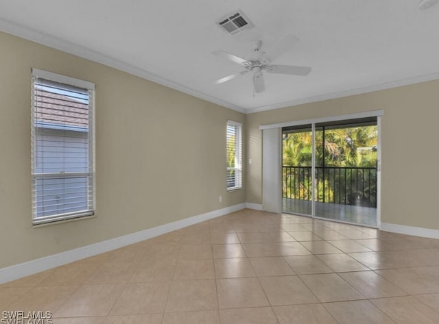 empty room with light tile patterned floors, ceiling fan, and ornamental molding