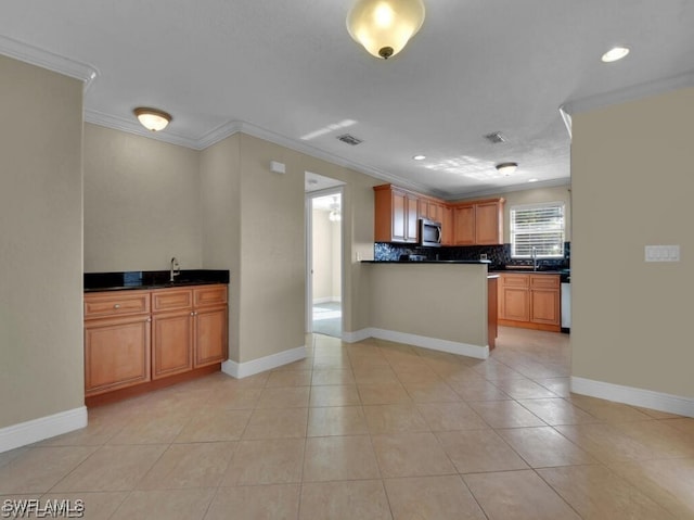 kitchen featuring tasteful backsplash, sink, light tile patterned floors, and ornamental molding