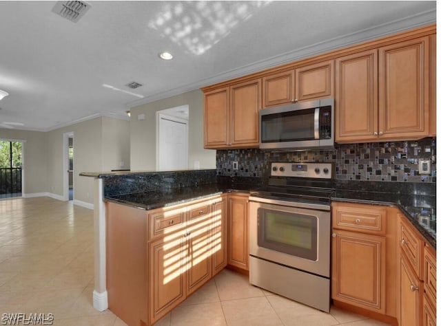 kitchen with tasteful backsplash, crown molding, appliances with stainless steel finishes, and dark stone counters