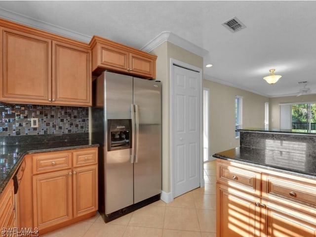 kitchen with backsplash, dark stone countertops, crown molding, and appliances with stainless steel finishes