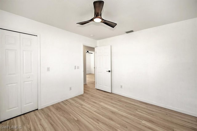 unfurnished bedroom featuring a closet, ceiling fan, and light hardwood / wood-style flooring