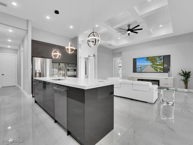 kitchen featuring sink, hanging light fixtures, coffered ceiling, beamed ceiling, and a kitchen island with sink