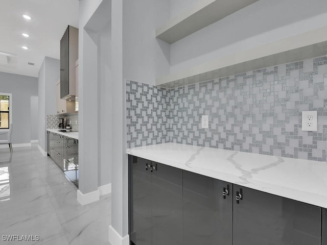 kitchen featuring light stone counters and black electric cooktop